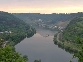 High angle view of river amidst trees against sky