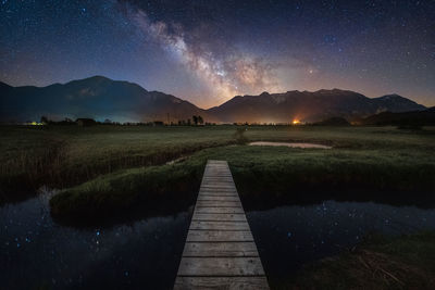 Scenic view of lake against sky at night