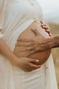 Midsection of woman holding hands