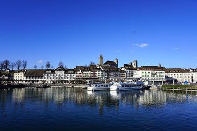 River by city against clear blue sky