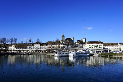 River by city against clear blue sky