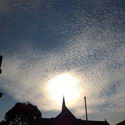 Low angle view of building against cloudy sky