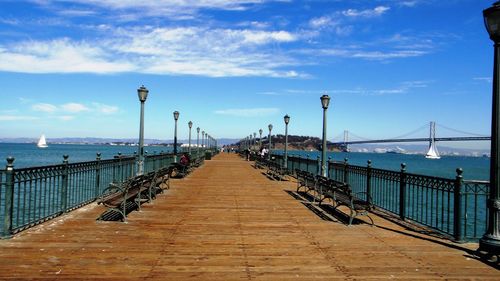 Empty walkway leading to sea