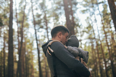 Father kissing son at forest