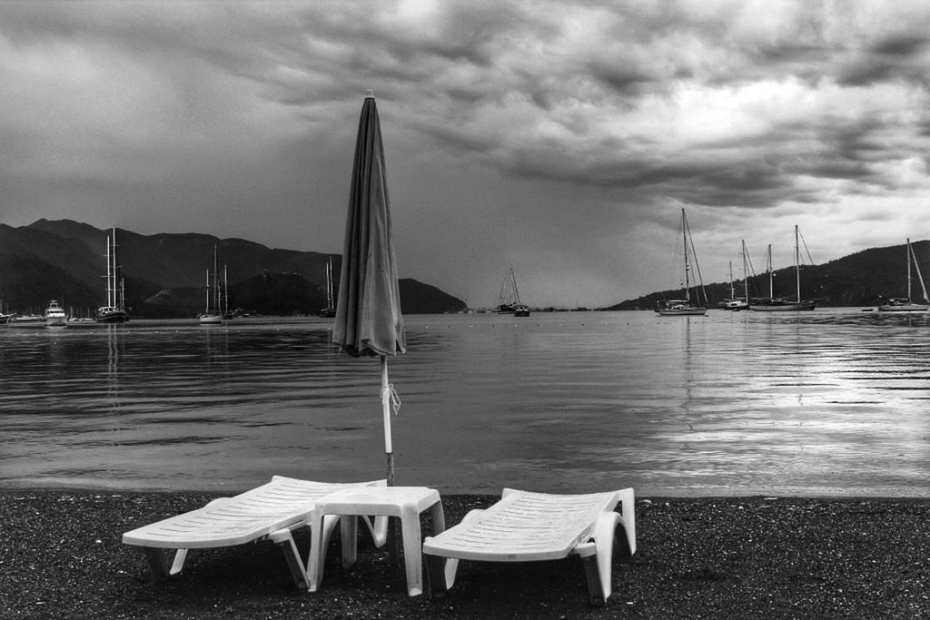 water, sky, sea, cloud - sky, empty, absence, tranquility, tranquil scene, cloud, chair, pier, table, nature, boat, nautical vessel, beach, cloudy, moored, outdoors, bench