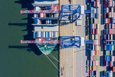 Container ship in import export and business logistic, by crane trade logistics concept, aerial view