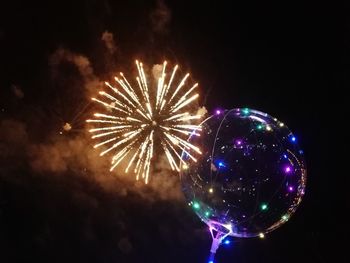 Low angle view of firework display at night