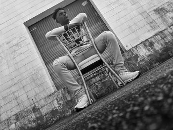 High angle view of man sitting on bench