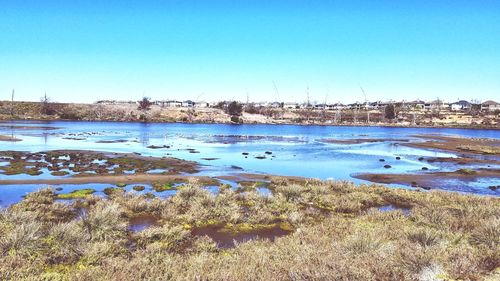 View of lake against blue sky