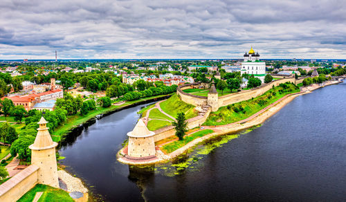 High angle view of river amidst buildings in city against sky