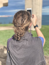 Rear view of woman photographing