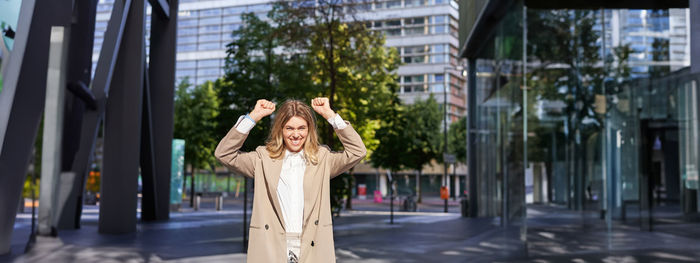 Rear view of woman standing in city