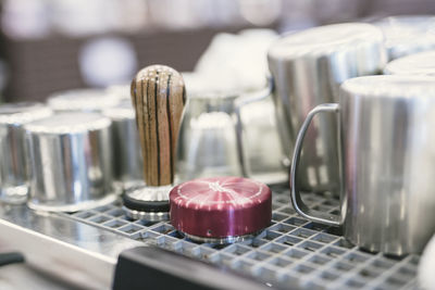 Close-up of kitchen utensils on metal grate