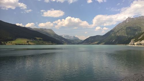 Scenic view of lake and mountains against sky