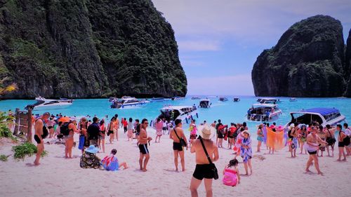 People on beach against sky