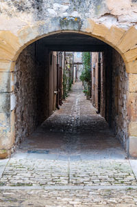 Narrow corridor along old building