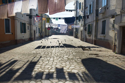 Laundry hanging on clotheslines amidst buildings