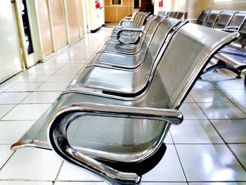 Empty chairs in tiled floor