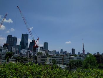 View of cityscape against blue sky