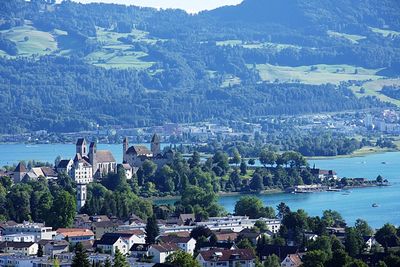 Aerial view of town by sea against sky