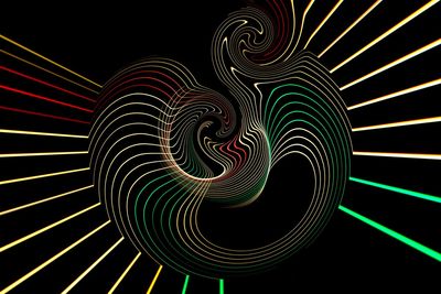 Low angle view of illuminated lights against black background