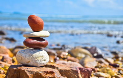 Close-up of pebbles on rock at sea shore