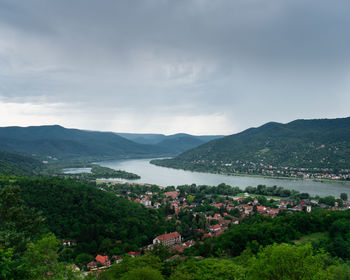 Scenic view of townscape and mountains against sky