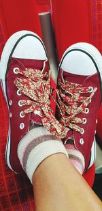 Low section of woman wearing canvas shoes
