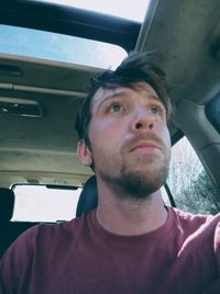 Portrait of young man in car