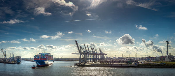 Scenic view of city by sea against sky