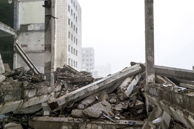 Abandoned building against sky in city