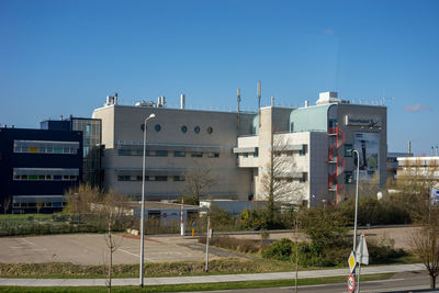 Buildings against clear blue sky