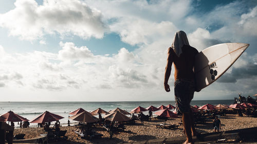 Man on beach against sky