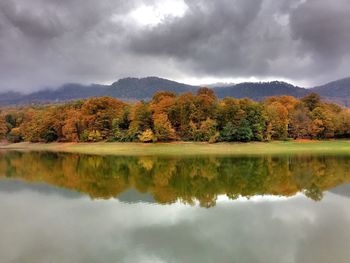 Scenic view of lake against cloudy sky