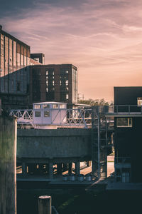 Buildings in city against sky during sunset