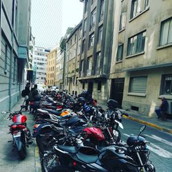 Bicycles parked on street amidst buildings in city