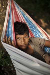 Portrait of young woman sitting on hammock