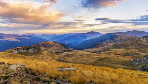 Scenic view of mountains against cloudy sky