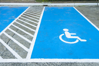 High angle view of disabled sign on footpath