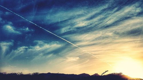 Low angle view of vapor trails in sky
