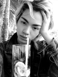 Portrait of young woman drinking glasses