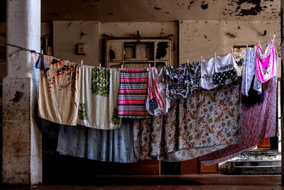 Clothes drying against wall at market
