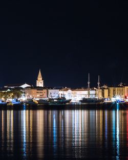 Reflection of illuminated buildings in water at night