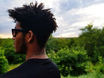 Man on tree against sky