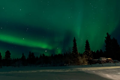Scenic view of landscape against sky at night during winter