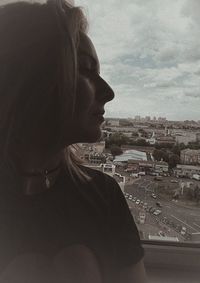 Portrait of man in city against sky