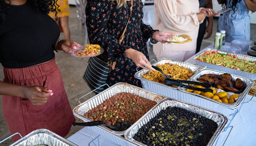 People serving themselves catered latin food at a social gathering