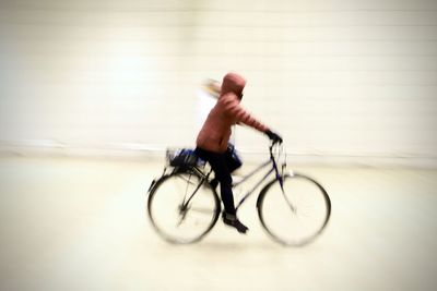 Side view of man riding bicycle