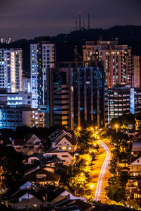 High angle view of illuminated buildings in city at night