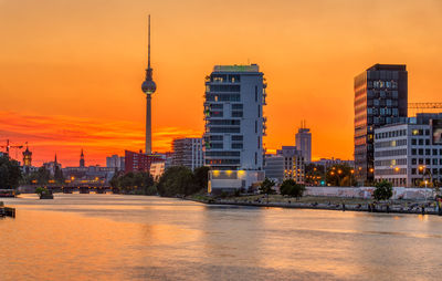 Buildings in city during sunset